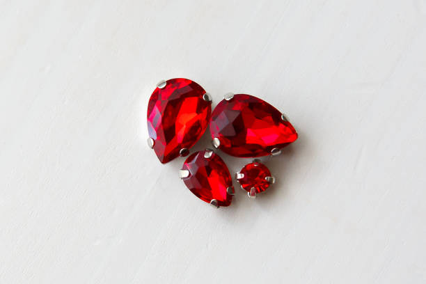 istock Red stones crystals beads on a white wooden background 1313639649