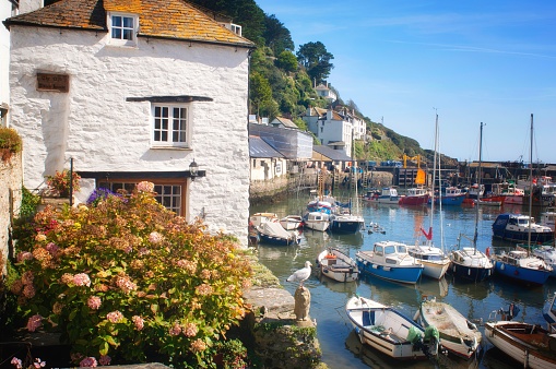 Polperro, Cornwall, UK - July 5th, 2019:A pretty cottage beside the harbour at Polperro, a major tourist destination in the UK. Property like this are much sought after as second homes and holiday lets.