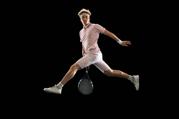 istock One Caucasian man, professional tennis player isolated on black background. 1313640032