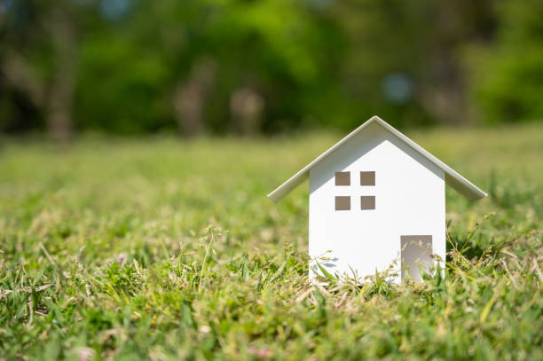 istock White paper house on the lawn with copy space on the left. 1313640076
