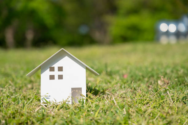 istock White paper house on the lawn with copy space on the right. 1313640108
