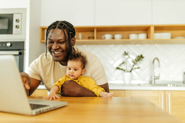 istock Happy man with his infant daughter looking at digital tablet. 1313641437
