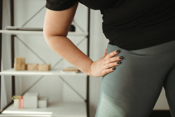 istock Young overweight woman doing home sport exercises 1313641561