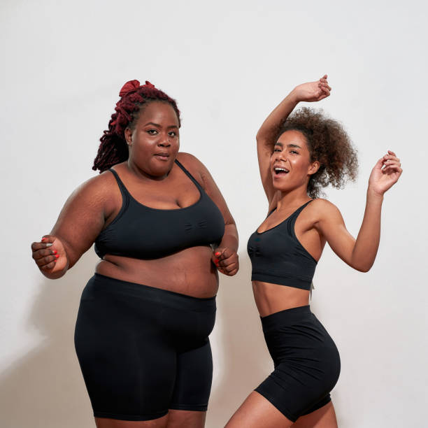 istock Black women dancing over the bright background, playful mood 1313642610