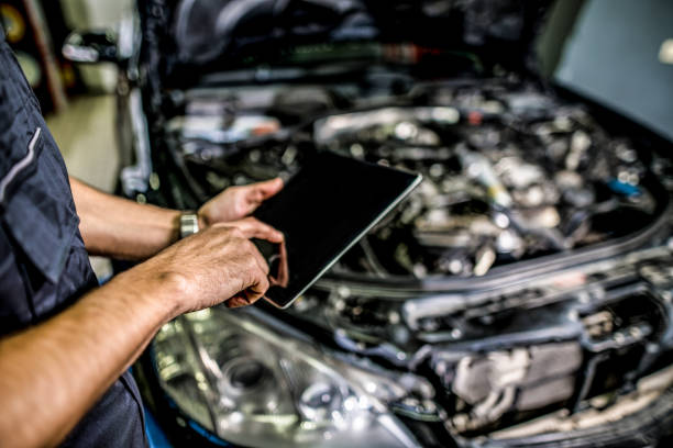 istock Mechanic using digital tablet in auto repair shop. 1313642972