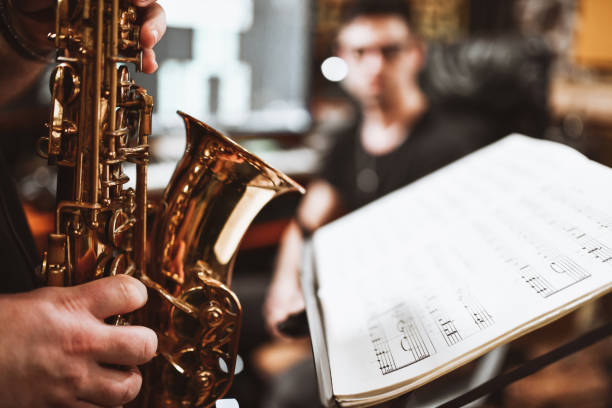 istock Saxophonist Playing According To Sheet Music In Studio 1313643048