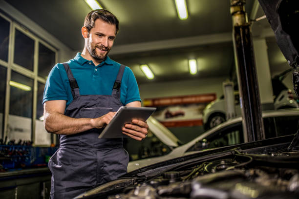 istock Happy mechanic using digital tablet in auto repair shop. 1313643450