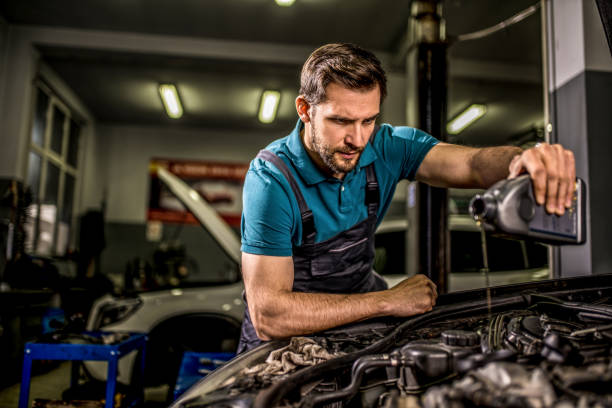istock Mechanic changing oil on the vehicle at car workshop. 1313643924