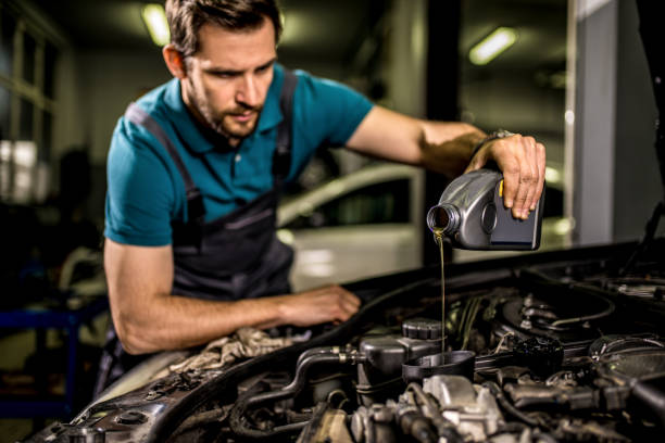 istock Mechanic changing oil on the vehicle at car workshop. 1313643973