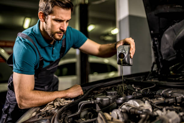 istock Mechanic changing oil on the vehicle at car workshop. 1313644007