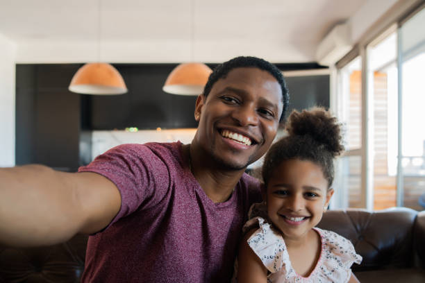 istock Daughter and father taking a selfie at home. 1313644153