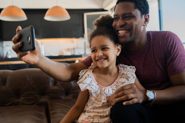 istock Daughter and father taking a selfie with phone. 1313644155