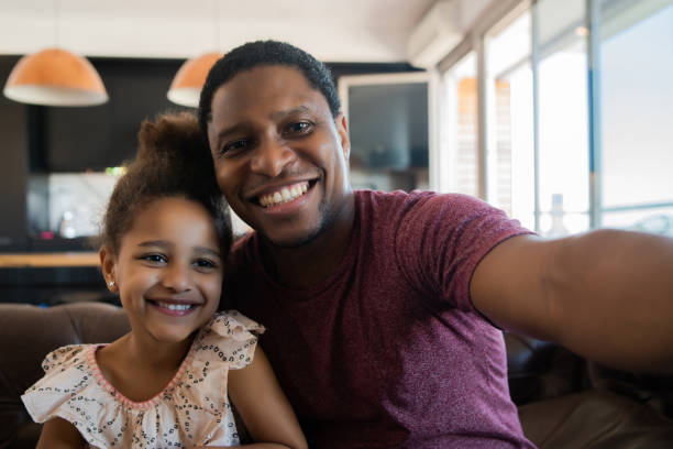 istock Daughter and father taking a selfie at home. 1313644157