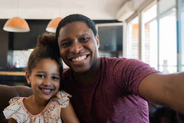 istock Daughter and father taking a selfie at home. 1313644168