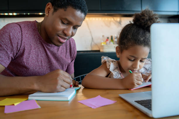 istock A father helping his daughter with homeschool. 1313644174
