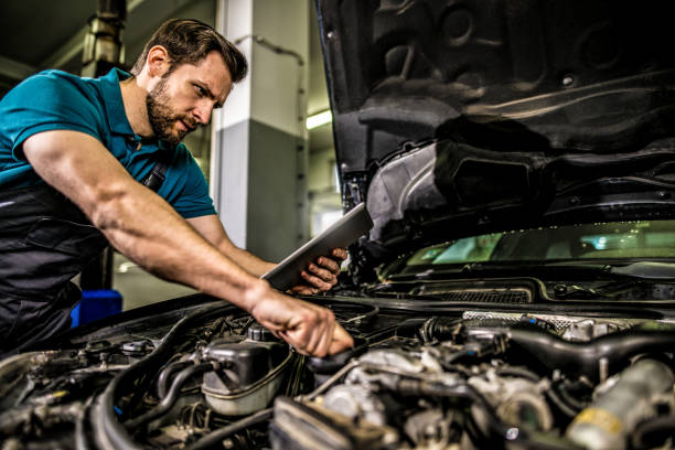 istock Mechanic using digital tablet in auto repair shop. 1313644263