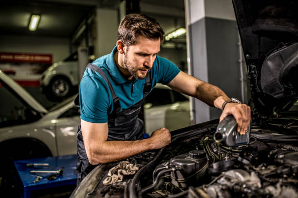 istock Mechanic changing oil on the vehicle at car workshop. 1313644295