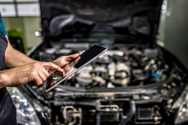 istock Mechanic using digital tablet in auto repair shop. 1313644354