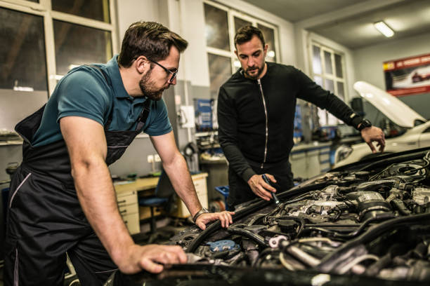 istock Two auto mechanics repairing car's engine. 1313644914