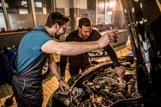 istock Two auto mechanics repairing car's engine. 1313645477