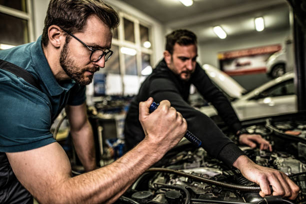 istock Two auto mechanics repairing car's engine. 1313645525