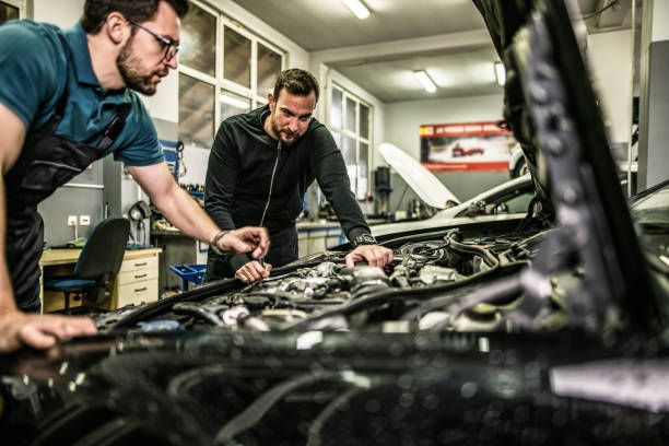 istock Two auto mechanics repairing car's engine. 1313645539