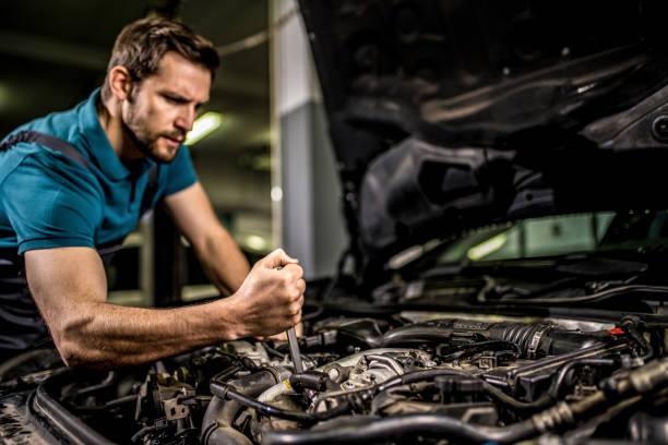 istock Auto mechanic repairing car's engine at car workshop. 1313645702