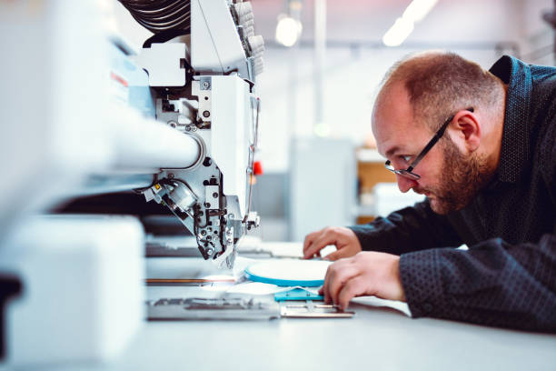 istock Balding Male Expert Using Sewing Machine In Textile Factory 1313645750