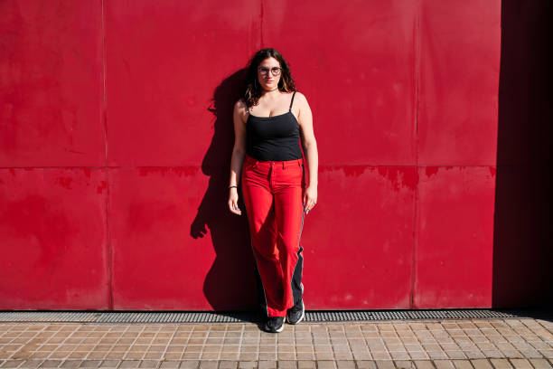 istock young curvy model with glasses and a red background 1313646466