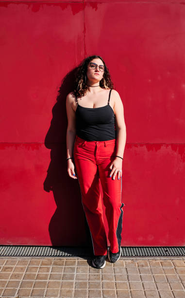 istock young curvy model in a sunny day with a red background 1313646471