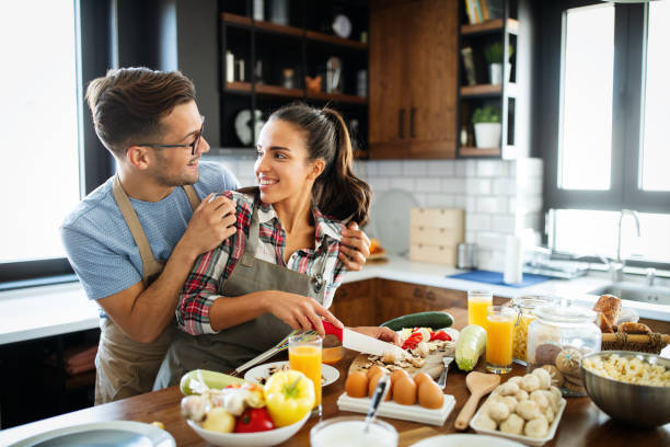 istock Beautiful young couple having fun in the kitchen while cooking. 1313648112