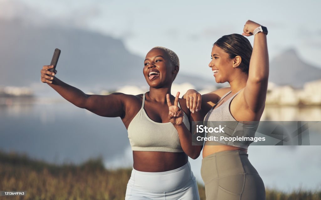 Shot of two women taking a selfie while out for a run
together We in on the bestie fitness challenge! Exercising Stock Photo