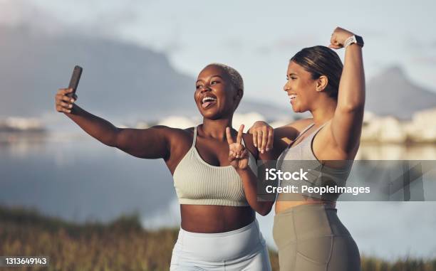 Shot Of Two Women Taking A Selfie While Out For A Run Together Stock Photo - Download Image Now