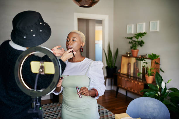 istock African woman getting her make-up done before a vlog post 1313649329