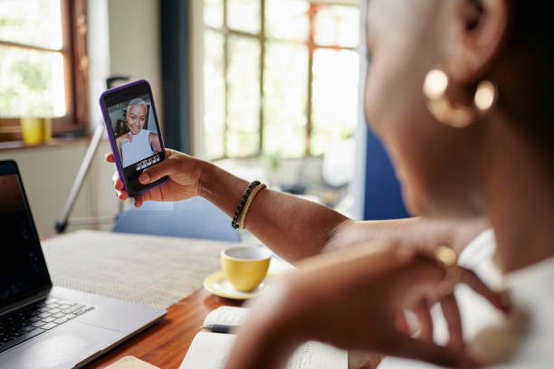 istock Young African influencer taking selfies while working on a laptop 1313649372