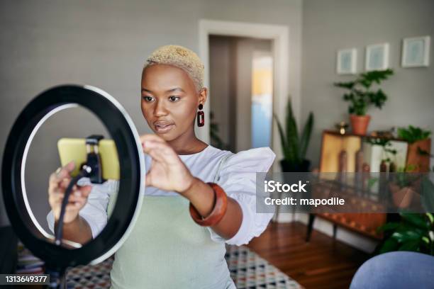 Young African Influencer Adjusting Her Smart Phone Before A Vlog Post Stock Photo - Download Image Now