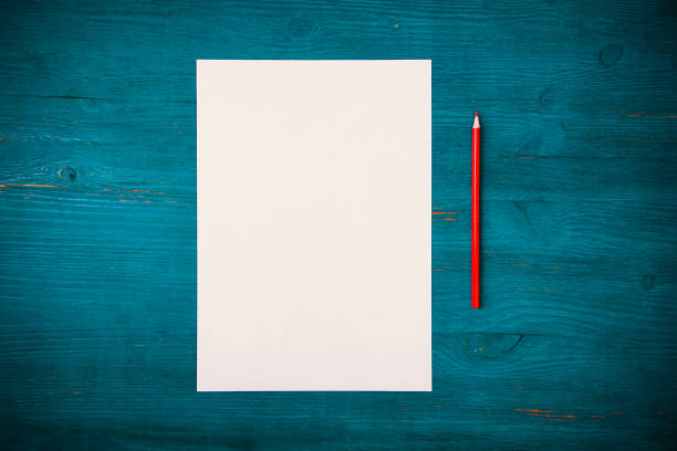 istock A blank white sheet and pencil for drawing on a wooden background with space for copying and lettering. 1313650511