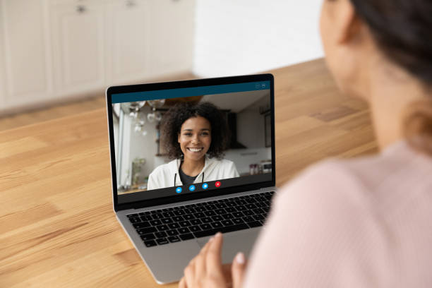 Young black woman answer friend by video call on pc Happy smiling young african female blogger in sportswear talk to web cam broadcast live from home on personal channel. Young black woman glad to answer friend by video call on pc screen in messenger divergent movie review stock pictures, royalty-free photos & images