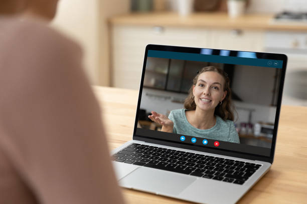 istock Pleasant millennial lady on laptop screen hold dialogue with friend 1313653242