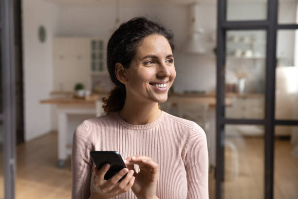 istock Happy young woman get message from beloved man on cell 1313653349