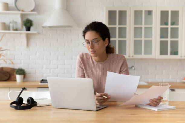 istock Thoughtful hispanic female hold financial documents look on pc screen 1313653693
