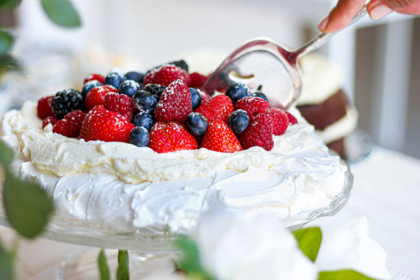 istock Pavlova cake with meringue, cream and red berries 1313656464