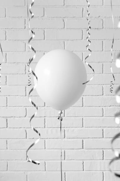istock white balloon against a gray brick wall. concept 1313657716