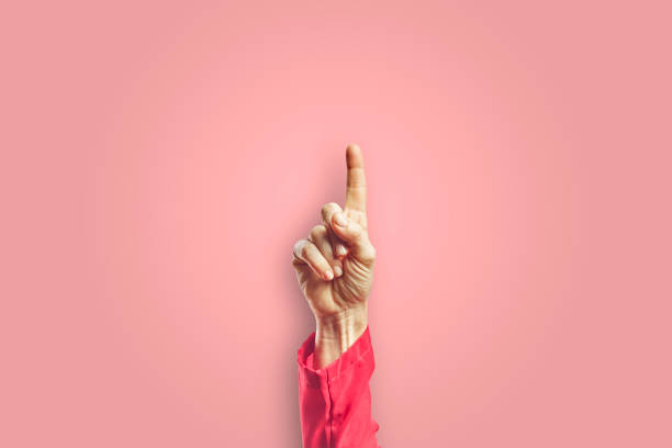 istock Woman arm making pointing gesture with hand isolated on pink background. 1313657758
