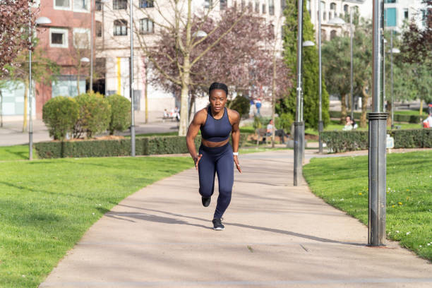 istock black afro girl running in a public park dressed as a runner 1313658426