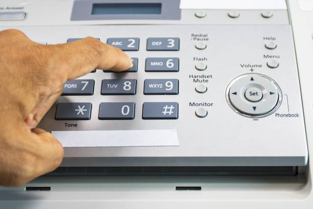 istock hand man are using a fax machine in the office, equipment for data transmission. 1313659130