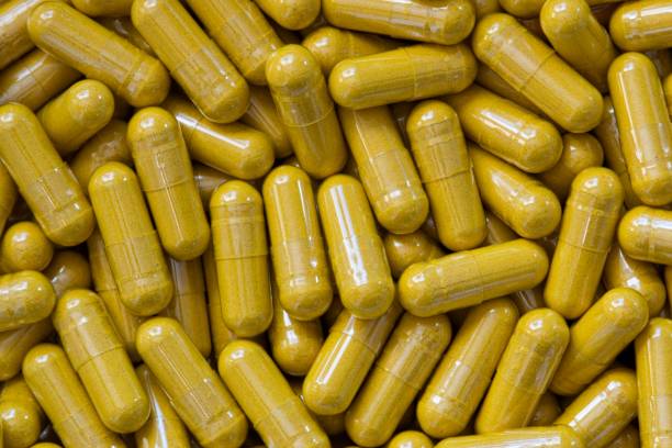 istock Turmeric Curcumin supplement capsules scattered loosely. 1313659547