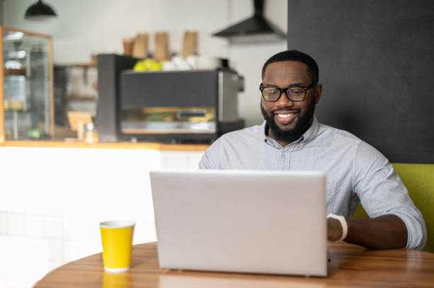 istock An African-American guy is sitting at the table in cozy cafe 1313659619