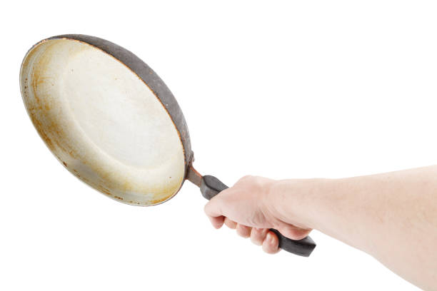 istock bare caucasian hand holding empty old aluminium frying pan 1313662400