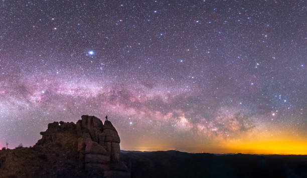 istock Hiker is standing next to the Milky Way galaxy 1313665277